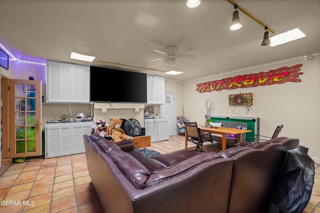 living room featuring ceiling fan and light tile patterned floors