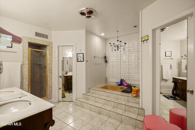 bathroom with vanity, an inviting chandelier, tile patterned floors, a textured ceiling, and independent shower and bath