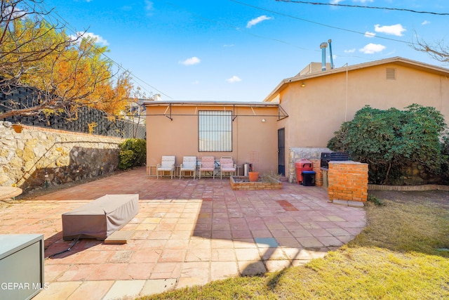 1117 Kerbey Ave, El Paso, TX 79902 - rear view of house featuring stucco siding and a patio