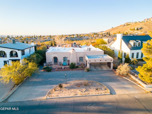 1117 Kerbey Ave, El Paso, TX 79902 - view of front of house with stucco siding and curved driveway