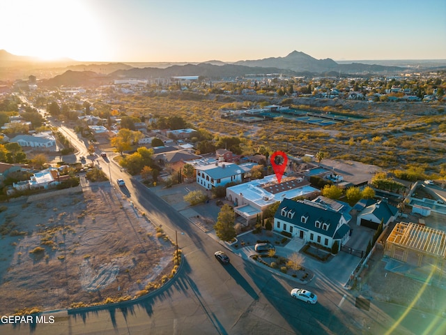 aerial view at dusk featuring a mountain view