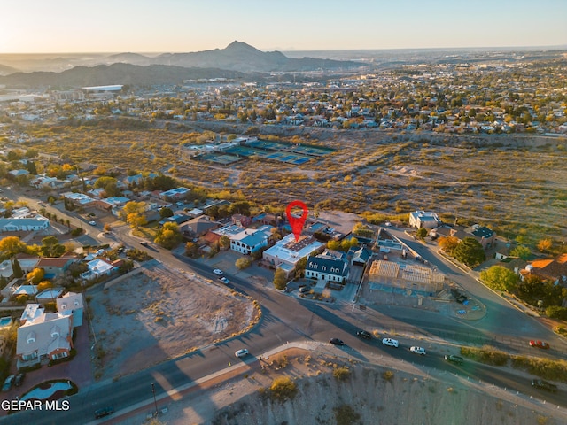 aerial view at dusk featuring a mountain view