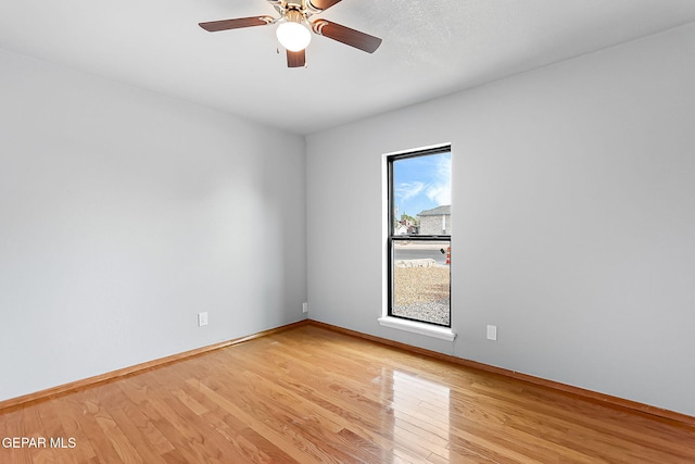 empty room featuring ceiling fan and light hardwood / wood-style floors