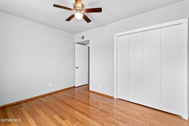 unfurnished bedroom featuring ceiling fan, a closet, and light hardwood / wood-style floors