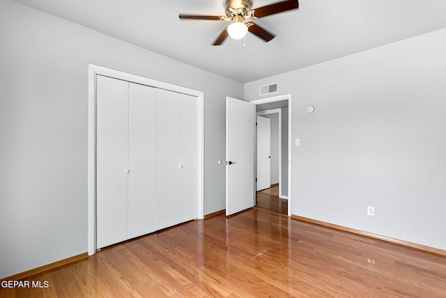 unfurnished bedroom featuring a closet, hardwood / wood-style flooring, and ceiling fan