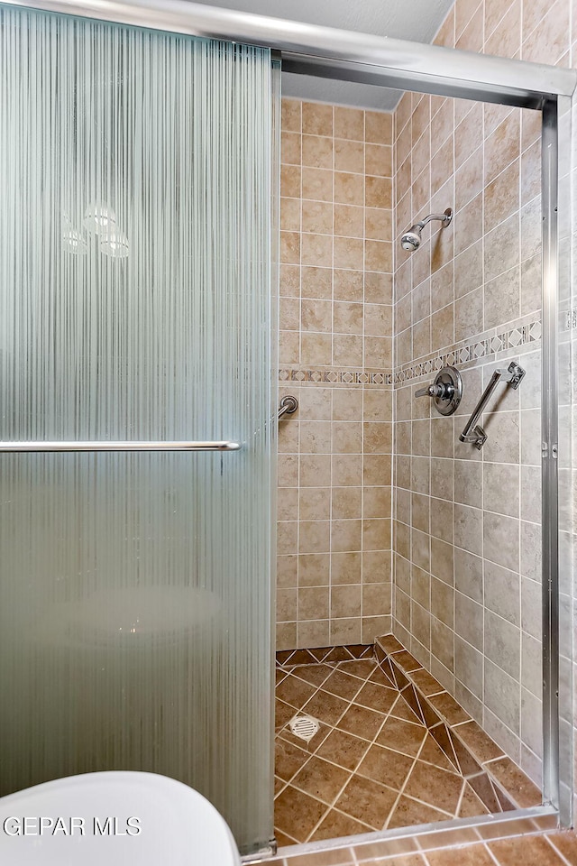 bathroom featuring tile patterned floors and an enclosed shower