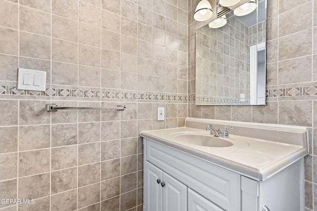 bathroom with vanity and tile walls