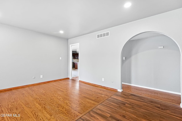 empty room with hardwood / wood-style floors