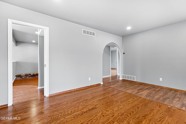 17001 Darrington Rd, Horizon City, TX 79928 - unfurnished room with wood finished floors, arched walkways, and recessed lighting