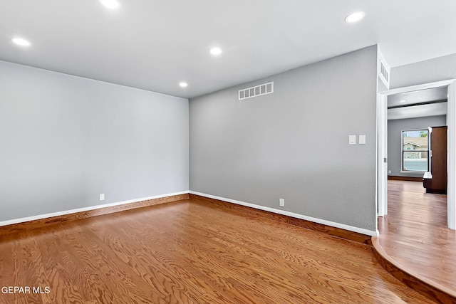 unfurnished room featuring hardwood / wood-style flooring