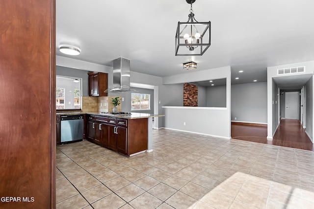 kitchen with dark brown cabinetry, wall chimney exhaust hood, stainless steel appliances, and a notable chandelier