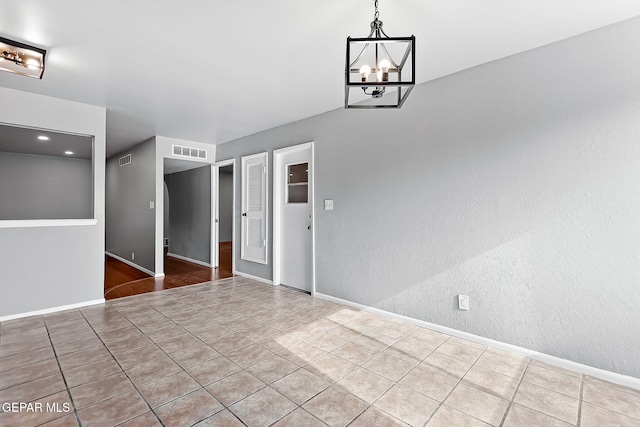 interior space featuring light tile patterned floors and an inviting chandelier