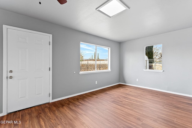 spare room featuring hardwood / wood-style floors and ceiling fan