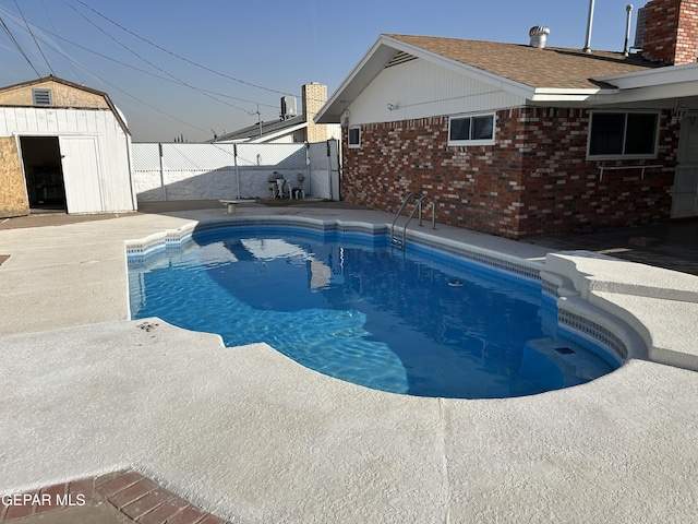 view of swimming pool featuring a storage shed