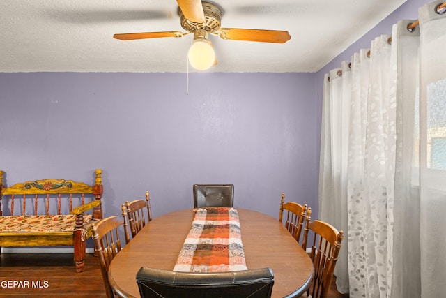 dining area with ceiling fan, hardwood / wood-style floors, and a textured ceiling