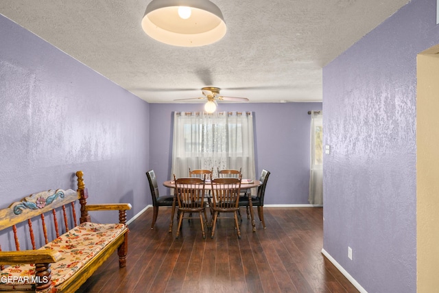 dining room featuring a textured ceiling, dark hardwood / wood-style floors, and ceiling fan