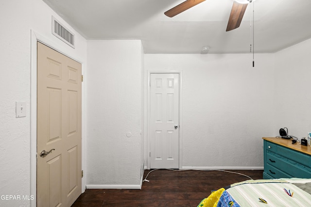 bedroom with dark hardwood / wood-style flooring and ceiling fan