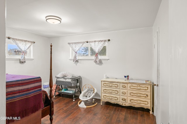 bedroom featuring dark hardwood / wood-style floors and multiple windows