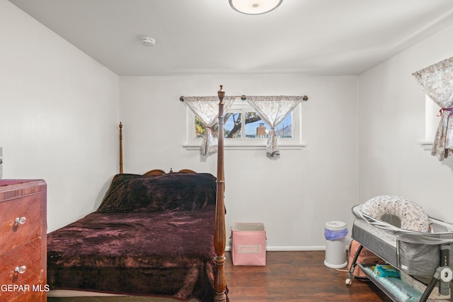 bedroom with dark hardwood / wood-style flooring