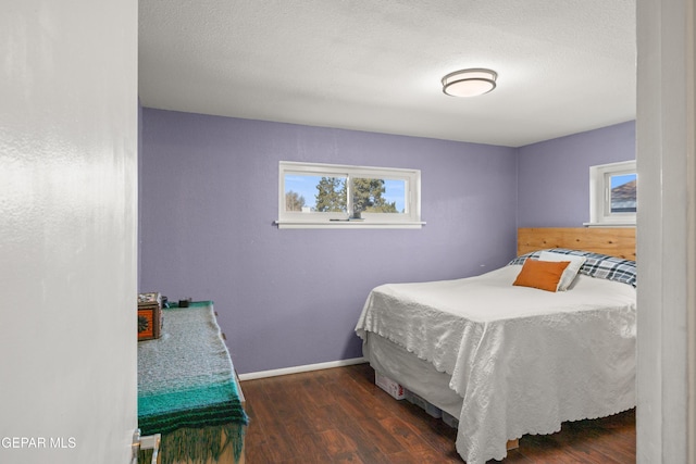 bedroom featuring dark wood-type flooring and a textured ceiling