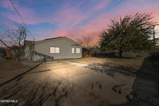 view of back house at dusk