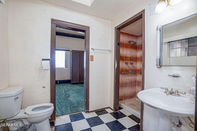 bathroom with walk in shower, sink, a textured ceiling, and toilet