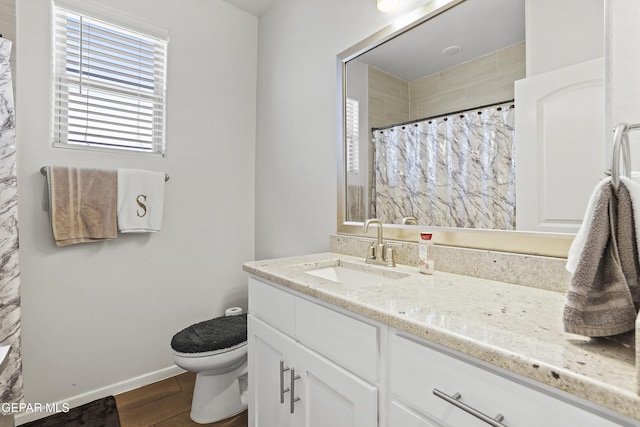 bathroom with vanity, a shower with shower curtain, and toilet