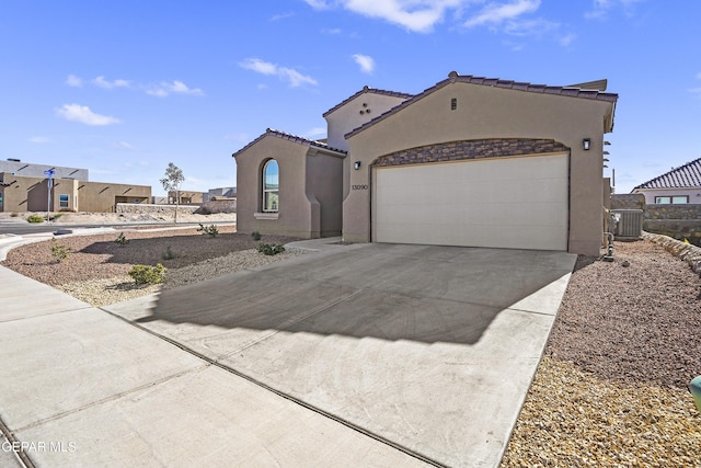 mediterranean / spanish-style home with a garage