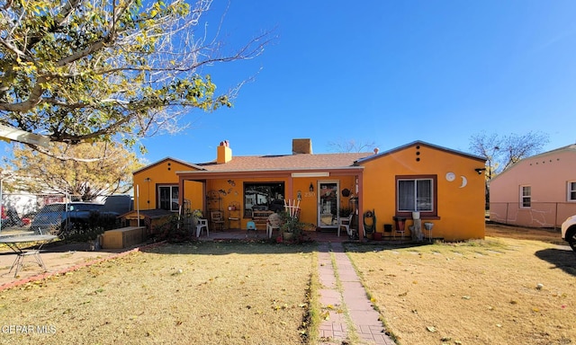 rear view of house featuring a lawn