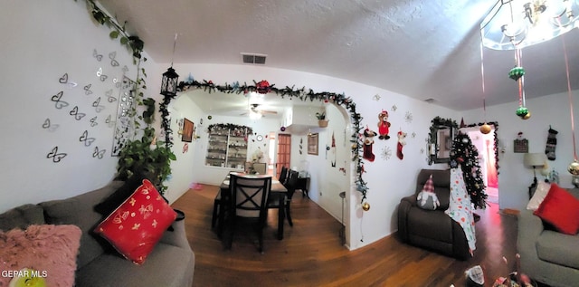 living room featuring ceiling fan, hardwood / wood-style floors, and lofted ceiling