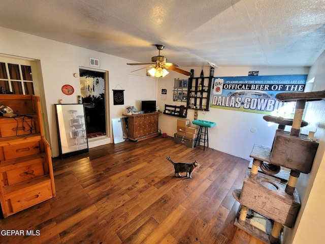 interior space with dark hardwood / wood-style floors, ceiling fan, and a textured ceiling