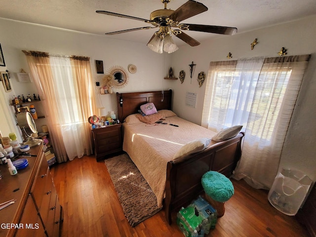 bedroom with hardwood / wood-style floors and ceiling fan