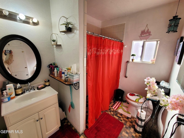 bathroom with vanity, toilet, and walk in shower