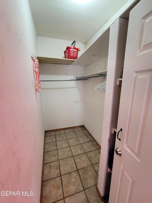 spacious closet featuring tile patterned floors