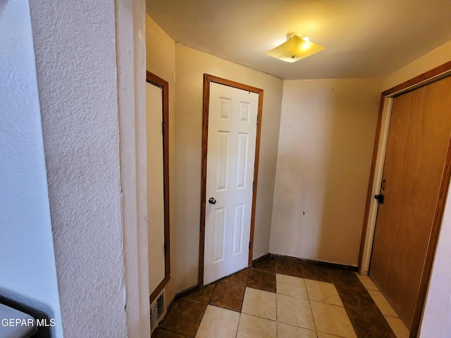 corridor with tile patterned flooring