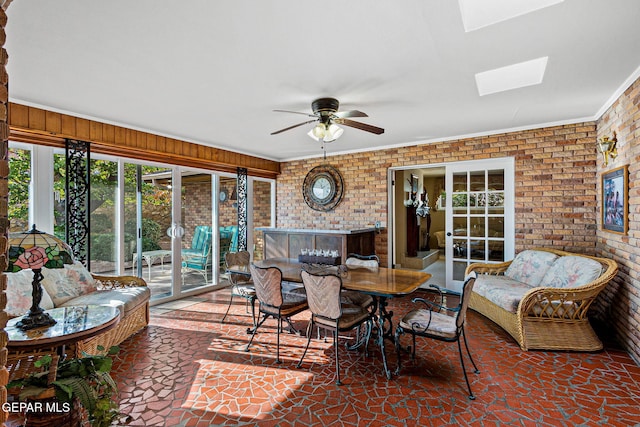 sunroom / solarium featuring ceiling fan and a skylight