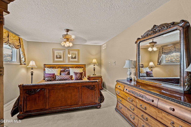 bedroom with light carpet and a textured ceiling