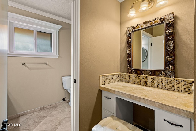 bathroom featuring crown molding, backsplash, vanity, a textured ceiling, and tile patterned floors