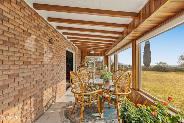 unfurnished sunroom with beam ceiling