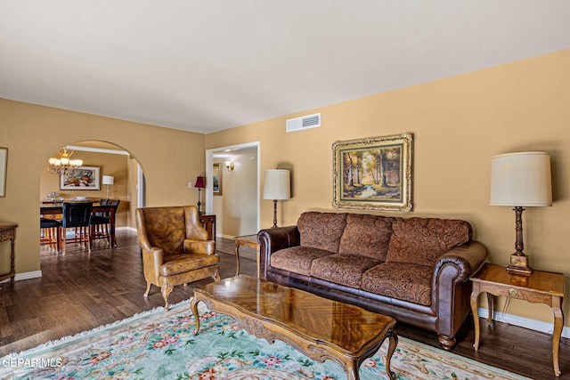 living room featuring hardwood / wood-style floors and an inviting chandelier