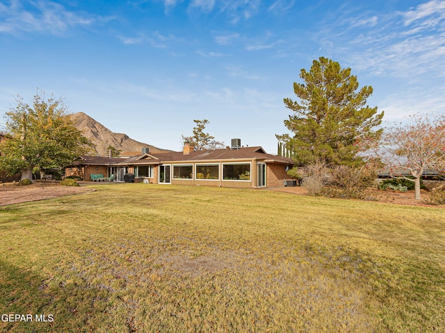 rear view of house with a yard