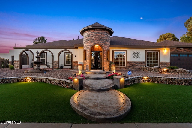 11179 Leo Collins Dr, El Paso, TX 79936 - view of front of home with stucco siding, stone siding, a yard, and french doors