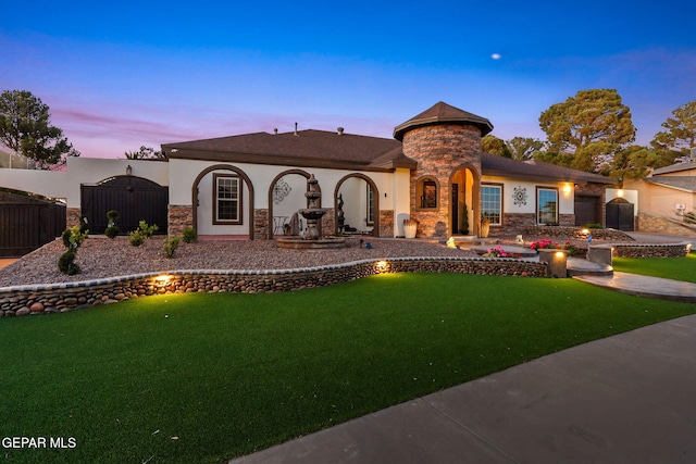 11179 Leo Collins Dr, El Paso, TX 79936 - view of front facade featuring stone siding, a lawn, and stucco siding