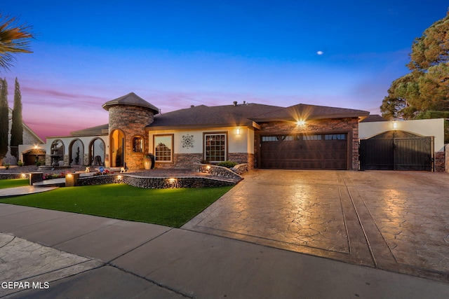 11179 Leo Collins Dr, El Paso, TX 79936 - view of front of house featuring a garage, stone siding, decorative driveway, a front lawn, and a gate