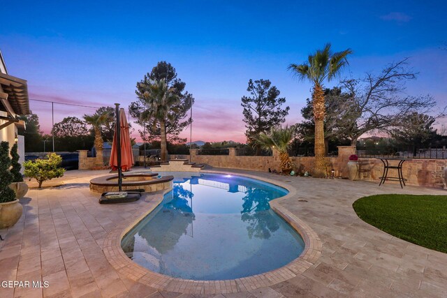 11179 Leo Collins Dr, El Paso, TX 79936 - pool at dusk with a patio and a pool with connected hot tub
