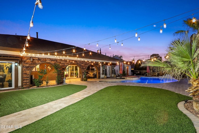 11179 Leo Collins Dr, El Paso, TX 79936 - yard at dusk featuring a patio, a yard, and a jacuzzi