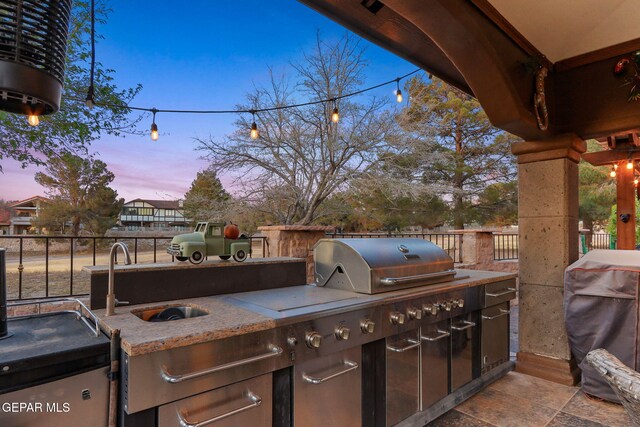 11179 Leo Collins Dr, El Paso, TX 79936 - patio terrace at dusk featuring area for grilling and a sink