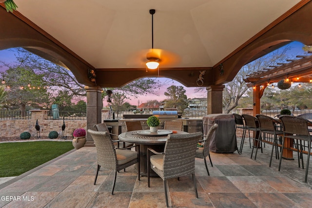 11179 Leo Collins Dr, El Paso, TX 79936 - patio terrace at dusk with a patio area, area for grilling, an outdoor bar, and outdoor dining space