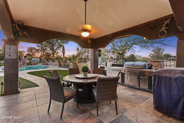 11179 Leo Collins Dr, El Paso, TX 79936 - patio terrace at dusk featuring area for grilling, outdoor dining space, and a patio area