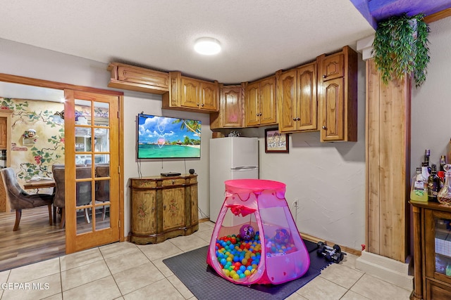 11179 Leo Collins Dr, El Paso, TX 79936 - recreation room with light tile patterned flooring and a textured ceiling